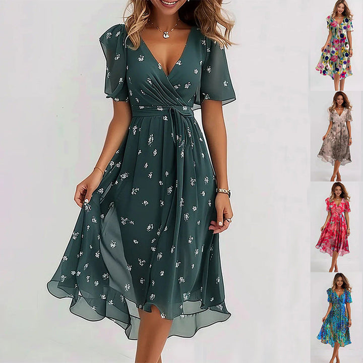Elegant printed dress in dark green with small white floral pattern, V-neck and flowy skirt