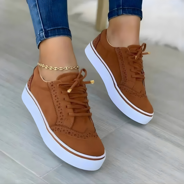 Brown lace-up orthopedic sneakers with perforated sides and white platform sole.
