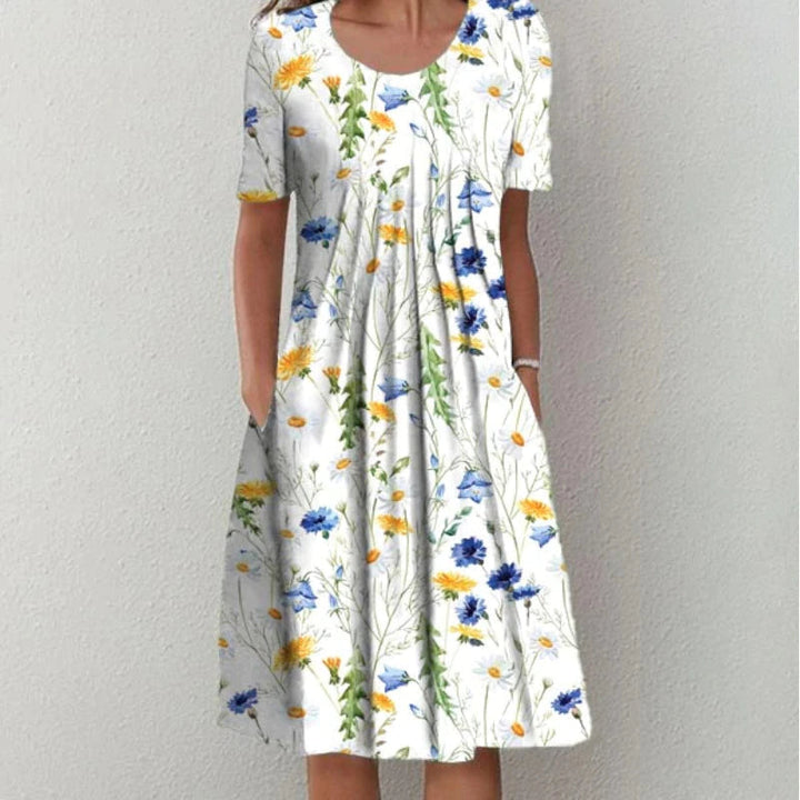 White floral tummy control dress with blue and yellow flowers, short sleeves, scoop neck