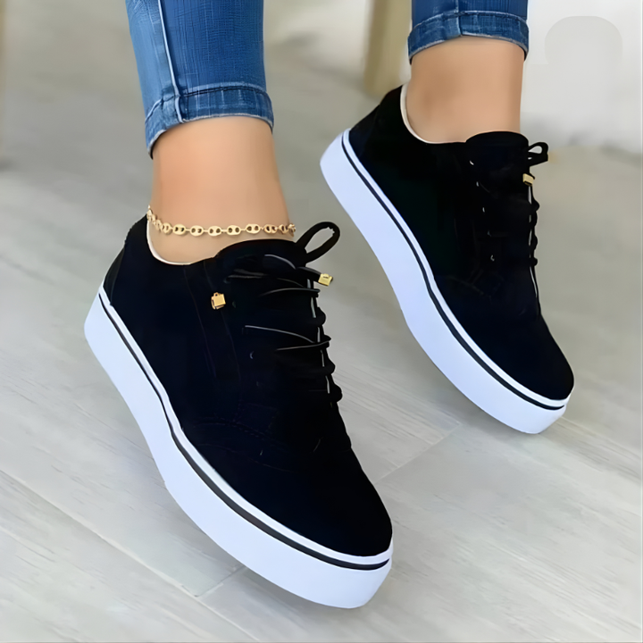 Black lace-up orthopedic sneakers with perforated panels and white platform sole.