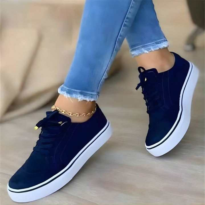 Navy lace-up orthopedic sneakers with perforated panels and white platform sole.