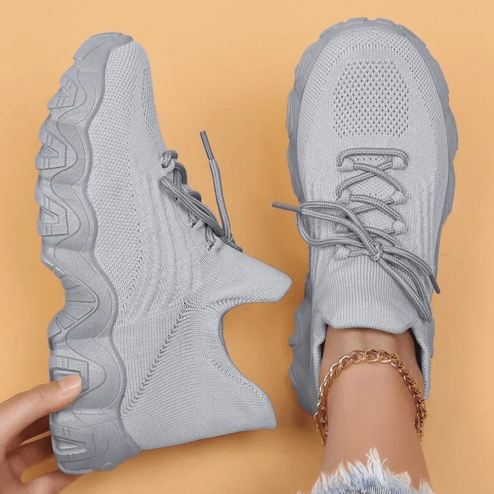 Grey knit lace-up sneakers with chunky tread sole, front and side view