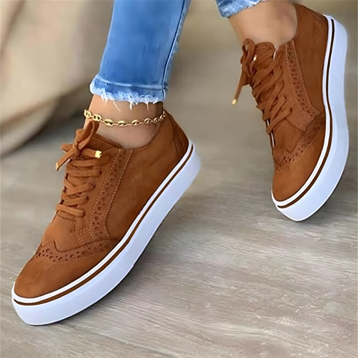 Brown lace-up orthopedic sneakers with perforated upper and white platform sole.