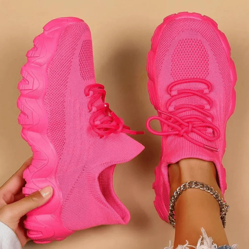 Pink knit lace-up sneakers with chunky tread sole, side view