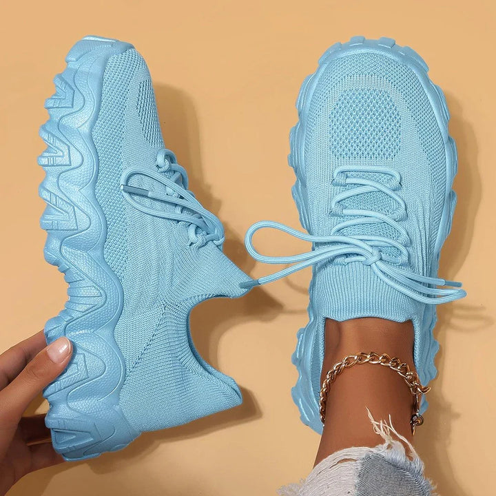 Sky blue knit lace-up sneakers with chunky tread sole, paired front views