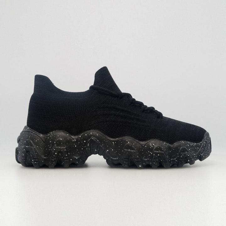Black knit orthopedic sneaker with lace-up closure and speckled chunky tread sole