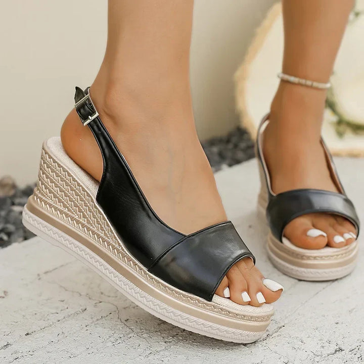 Black orthopaedic wedge sandals with open toe and adjustable ankle buckle strap