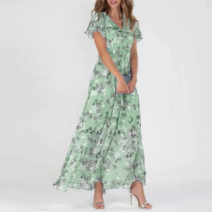 Green floral midi dress with V-neck, short flutter sleeves, and gathered skirt