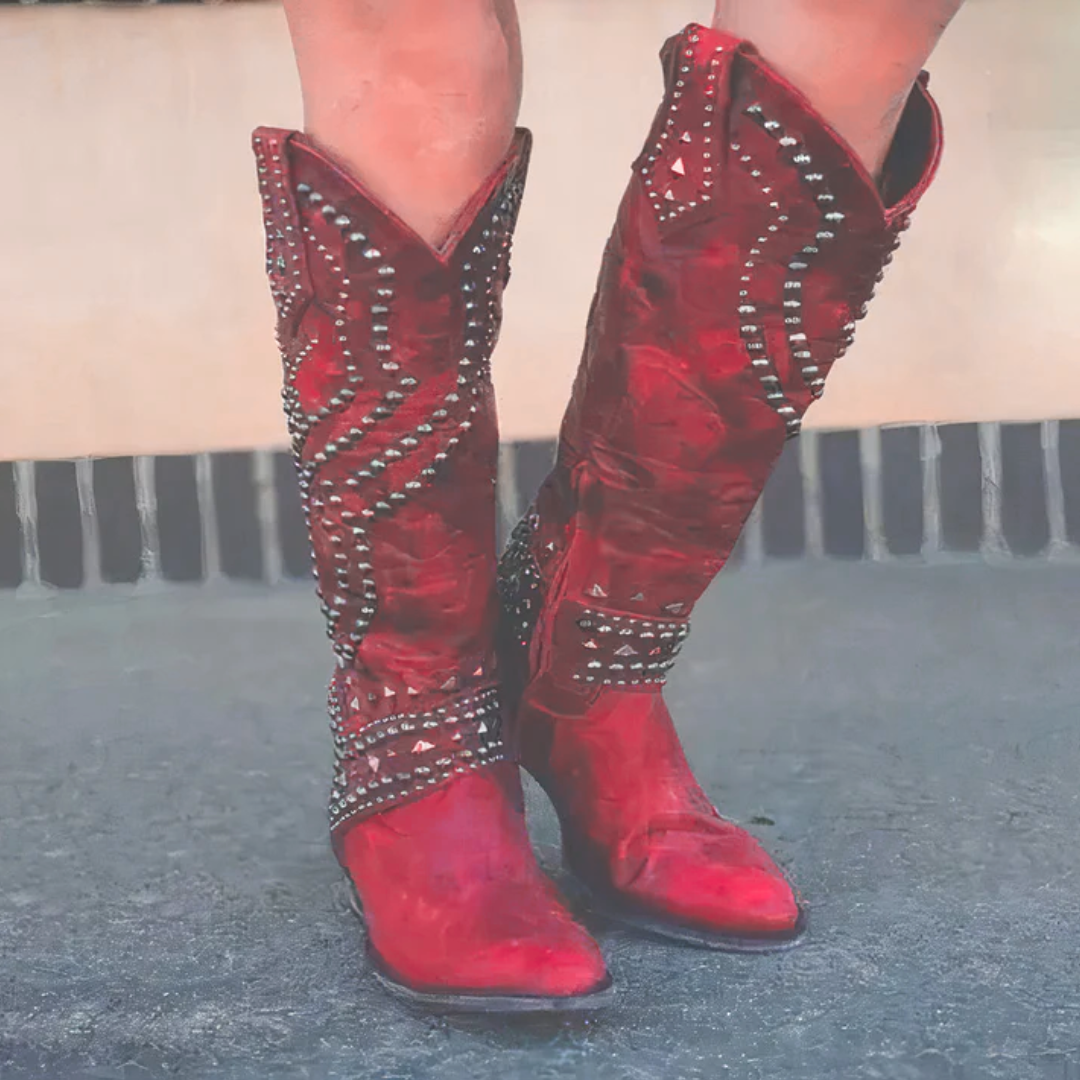 Red western knee-high boots with silver stud accents and stacked heel