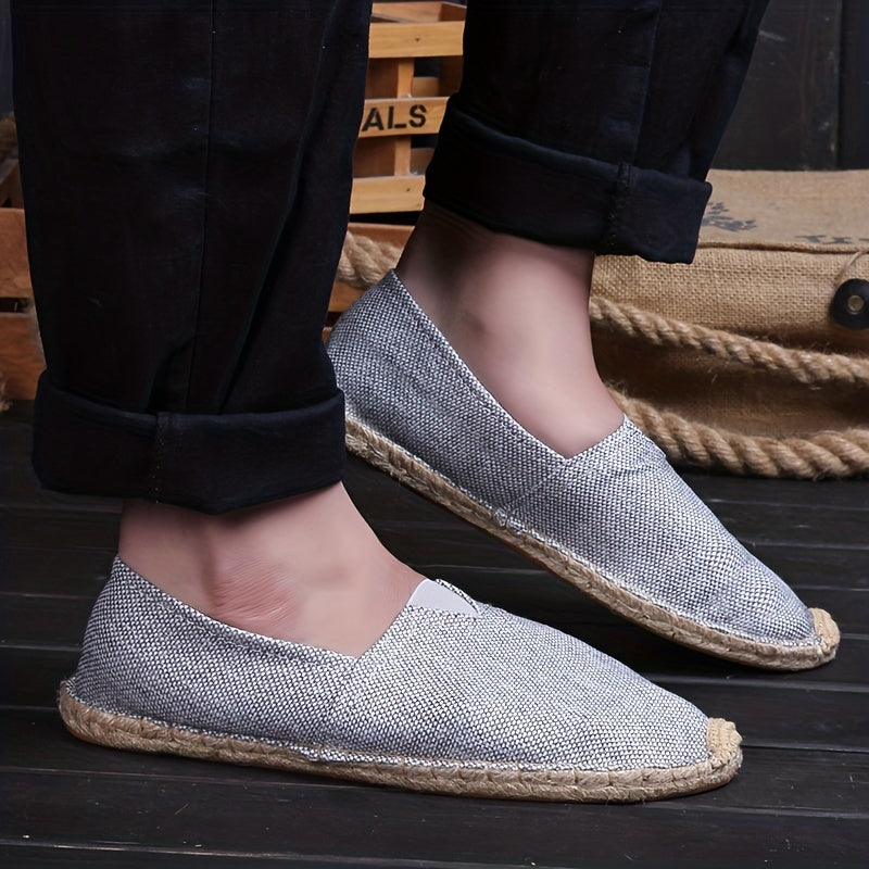 Grey espadrille flats with braided jute sole and V-cut vamp on foot