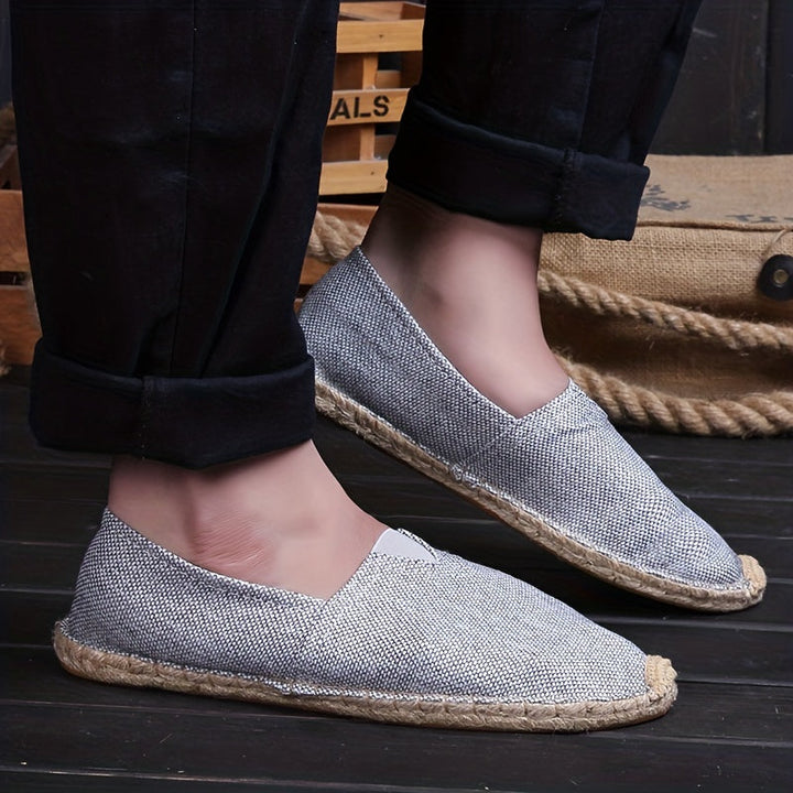 Grey espadrille flats with braided jute sole and V-cut vamp on foot