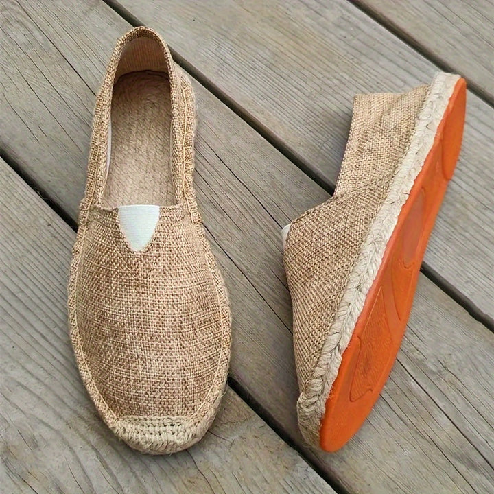 Beige espadrille slip-on with jute sole and peeks of orange rubber outsole