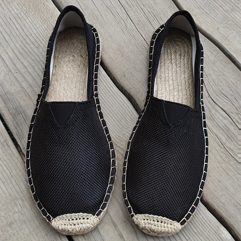 Pair of black espadrille slip-ons with woven jute soles and stitched side trim