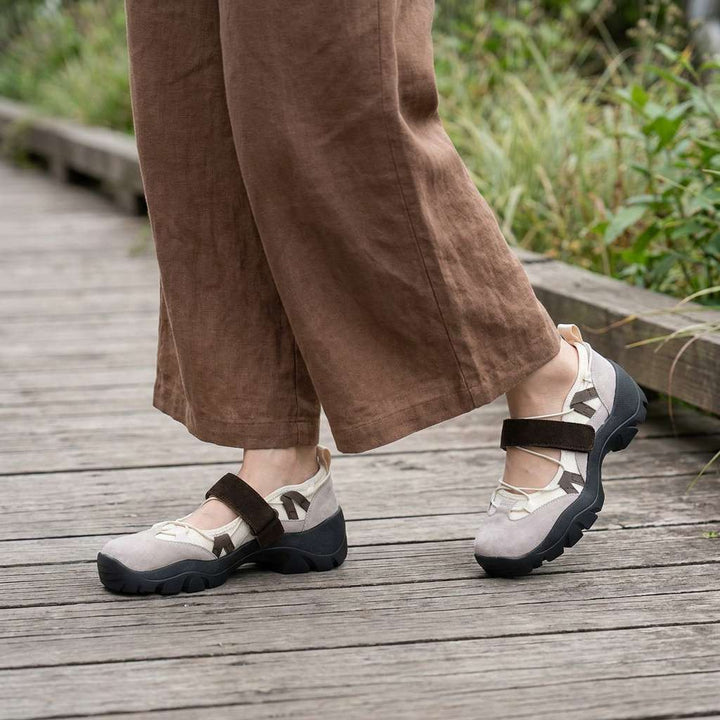 Two-tone comfort loafers (beige/black) with buckle strap and chunky tread sole