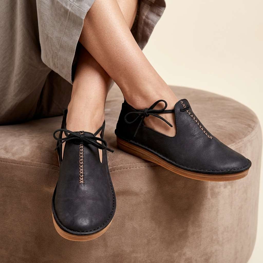 Black ComfortWalk loafers with lace-up ties and moc-toe stitching