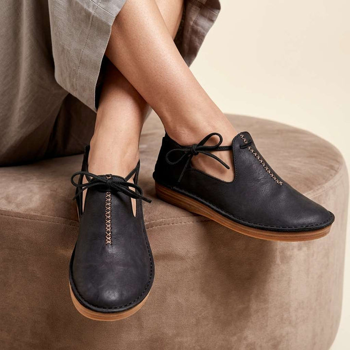 Black ComfortWalk loafers with lace-up ties and moc-toe stitching
