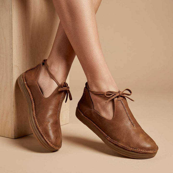 Tan ComfortWalk loafers with lace-up ties and stitched moc toe