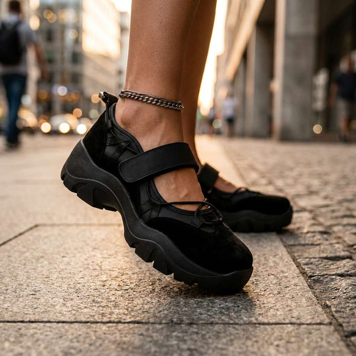 Black comfort loafers with adjustable strap and chain ankle detail, chunky sole